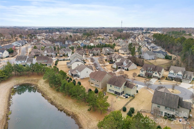 drone / aerial view featuring a residential view and a water view