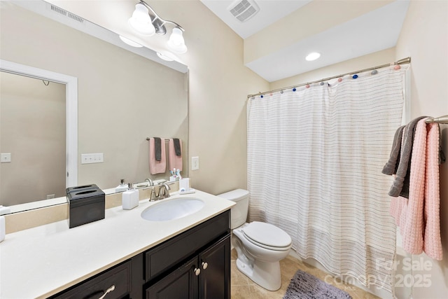 bathroom with toilet, vanity, tile patterned floors, and visible vents