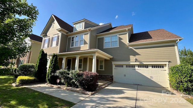 11519 Sweet Birch Ln, Charlotte, NC 28278 - craftsman house with driveway, a garage, covered porch, and a shingled roof