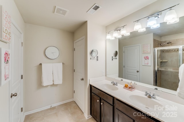 bathroom with vanity, tile patterned floors, and a shower with door