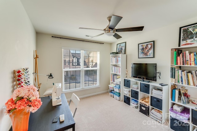 living area featuring carpet and ceiling fan