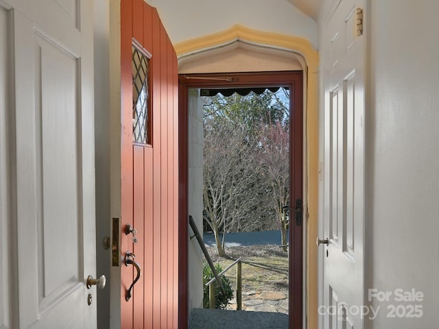 doorway featuring vaulted ceiling