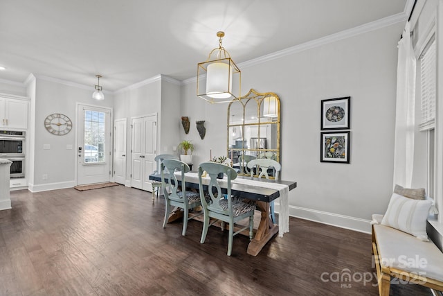 dining space featuring dark wood-type flooring and ornamental molding