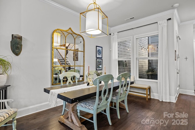 dining area with dark wood-type flooring and crown molding