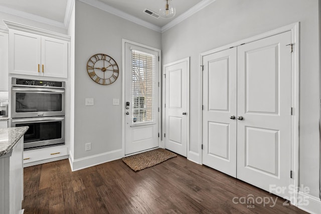 foyer featuring dark hardwood / wood-style floors and crown molding