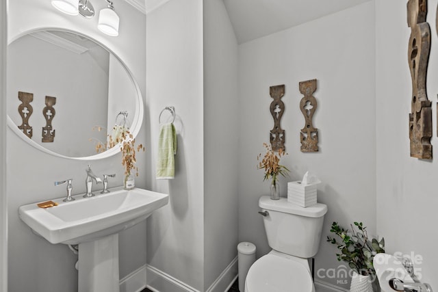 bathroom with toilet and ornamental molding