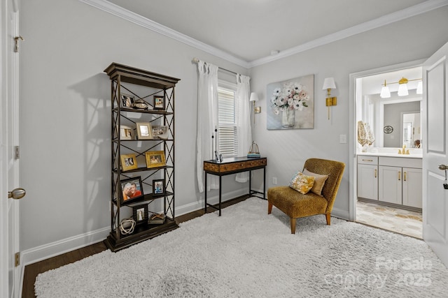 sitting room with dark wood-type flooring, sink, and ornamental molding