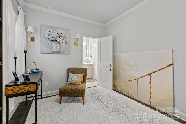 sitting room with ornamental molding and hardwood / wood-style floors