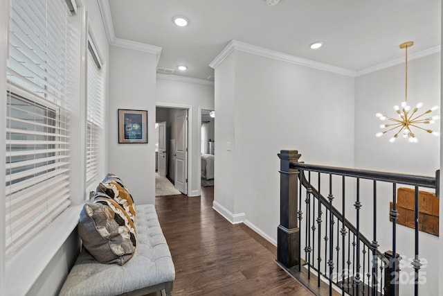 hall featuring an inviting chandelier, dark hardwood / wood-style floors, and crown molding