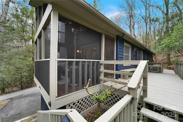 view of property exterior with a sunroom