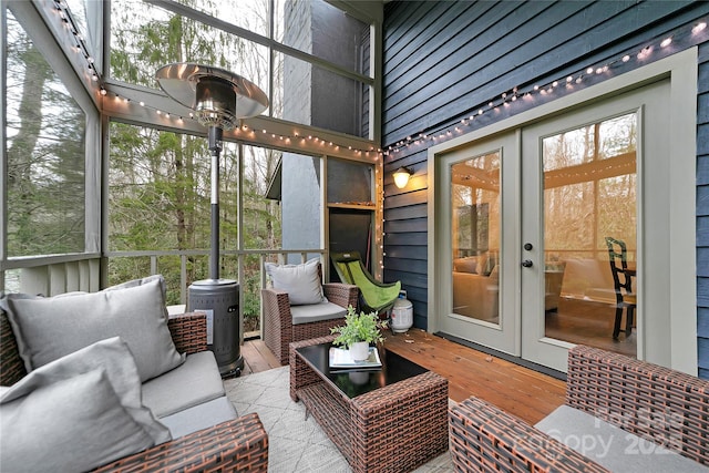 sunroom featuring french doors and a healthy amount of sunlight