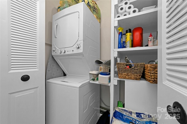 clothes washing area featuring stacked washer / dryer