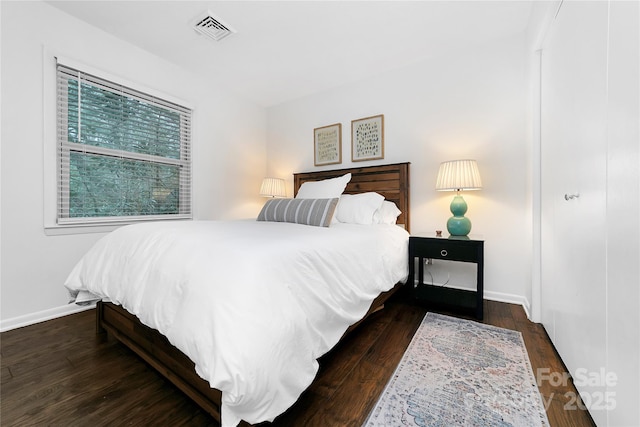 bedroom with dark wood-type flooring