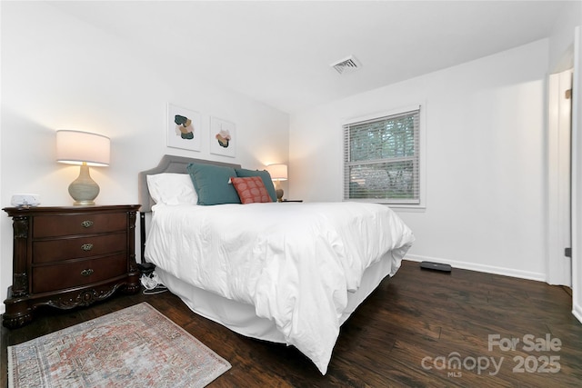 bedroom with dark hardwood / wood-style flooring