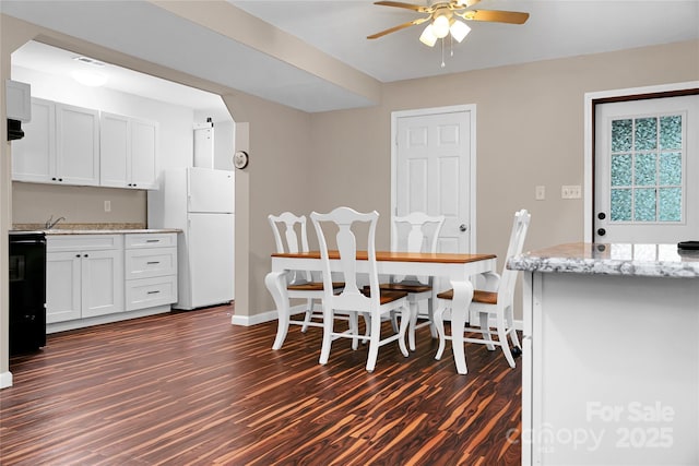 dining room featuring ceiling fan and dark hardwood / wood-style flooring