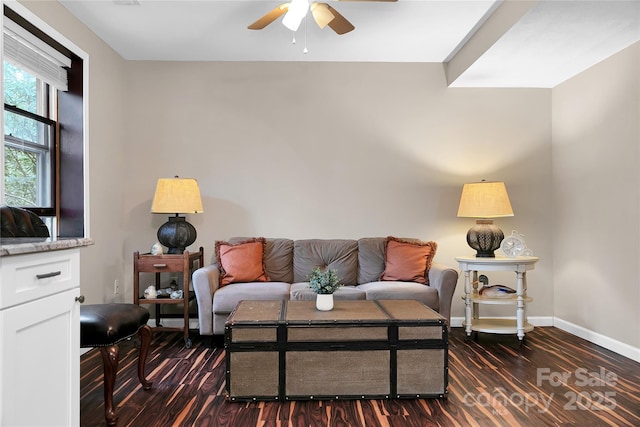 living room with dark wood-type flooring and ceiling fan