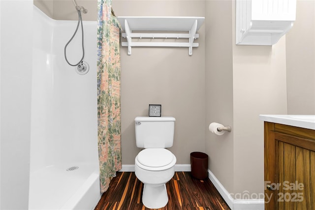 bathroom with wood-type flooring, a shower with curtain, toilet, and vanity