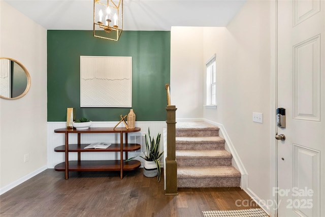 staircase featuring a notable chandelier and hardwood / wood-style flooring