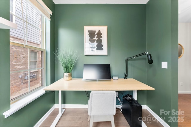 office featuring hardwood / wood-style flooring and a healthy amount of sunlight