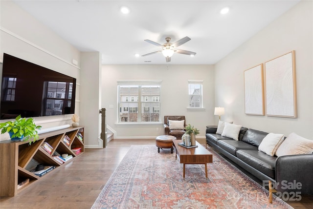 living room with hardwood / wood-style flooring and ceiling fan