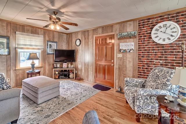 living room featuring ceiling fan and light hardwood / wood-style flooring