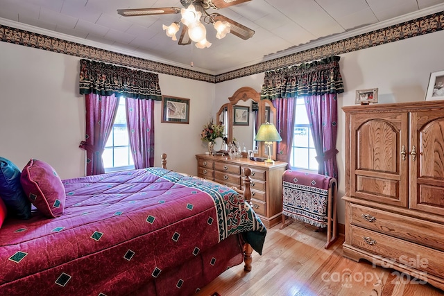 bedroom with crown molding, ceiling fan, and light wood-type flooring