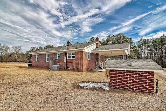 exterior space with central AC unit and a storage unit