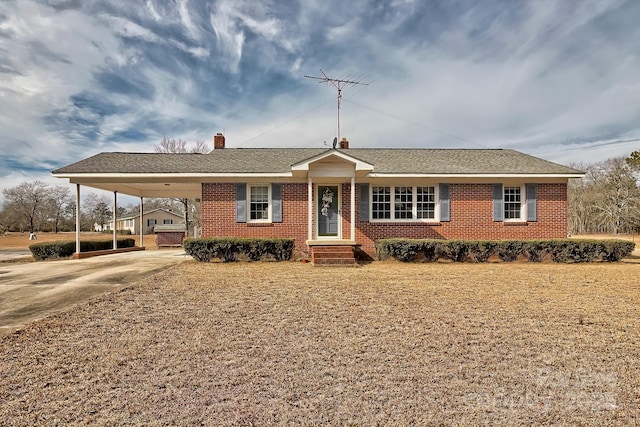 ranch-style home featuring a carport