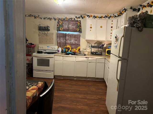 kitchen featuring dark hardwood / wood-style flooring, sink, white appliances, and white cabinets