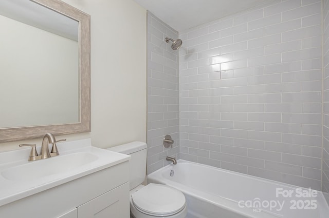 full bathroom with toilet, tiled shower / bath combo, and vanity