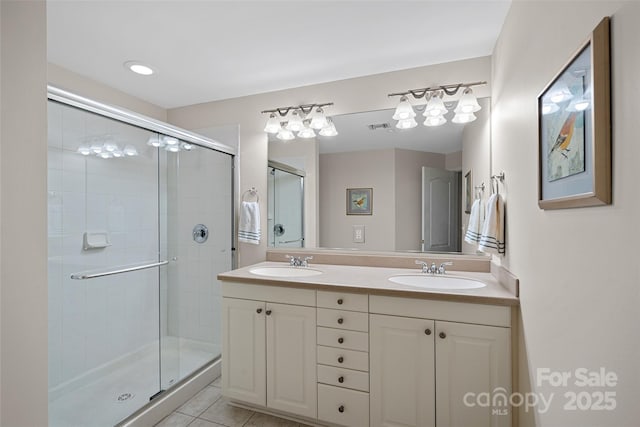 bathroom with tile patterned floors, an enclosed shower, and vanity