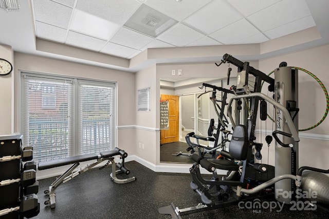 workout area featuring a paneled ceiling and a wealth of natural light