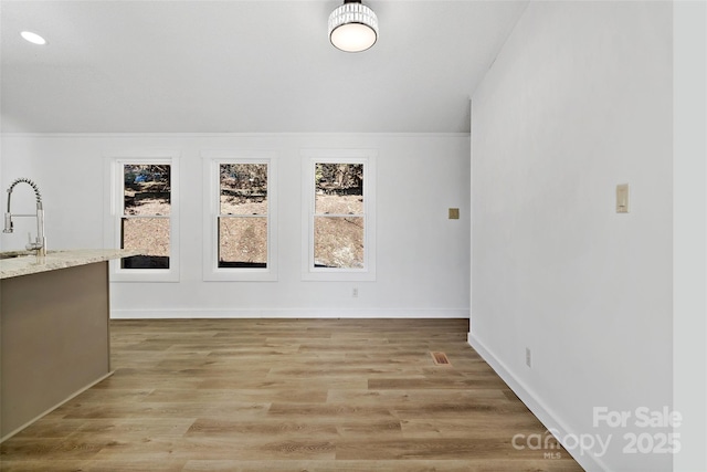 interior space with light hardwood / wood-style floors and sink