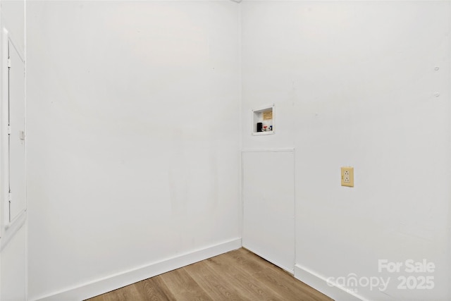 washroom with wood-type flooring and hookup for a washing machine