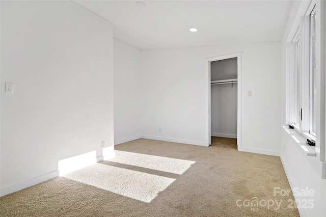 unfurnished bedroom with light carpet, a closet, and vaulted ceiling