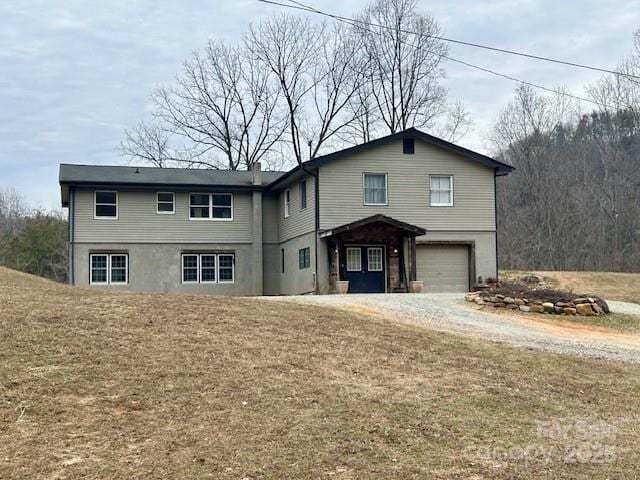 front of property with a garage and a front yard