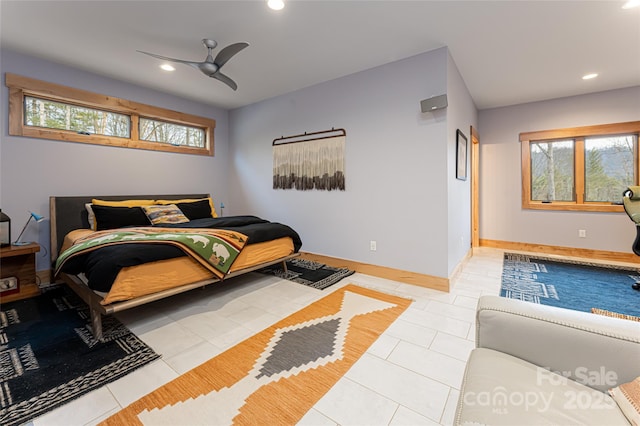 tiled bedroom featuring ceiling fan