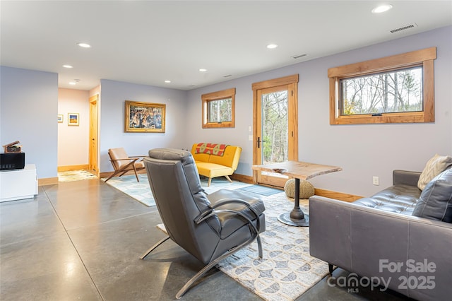 living room featuring concrete flooring