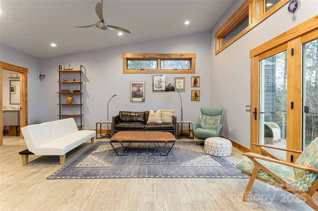 sitting room with ceiling fan, lofted ceiling, and light wood-type flooring