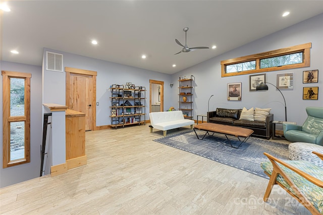 living room featuring ceiling fan, lofted ceiling, and light hardwood / wood-style floors