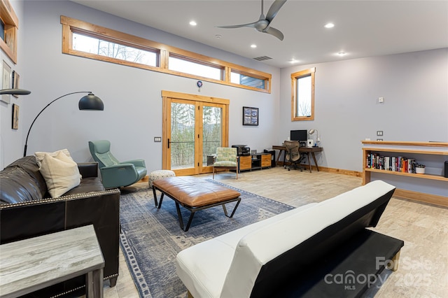 living room featuring hardwood / wood-style floors, ceiling fan, and french doors