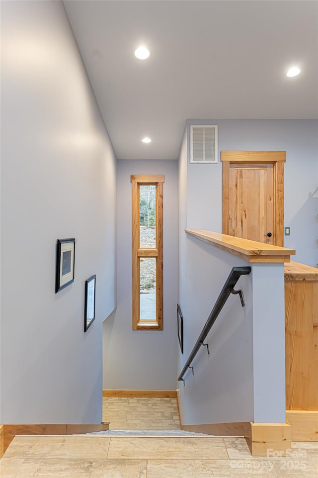 stairway featuring wood-type flooring