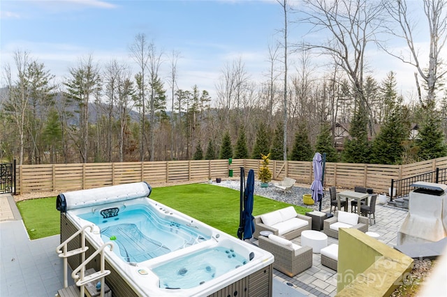 view of patio / terrace with a hot tub