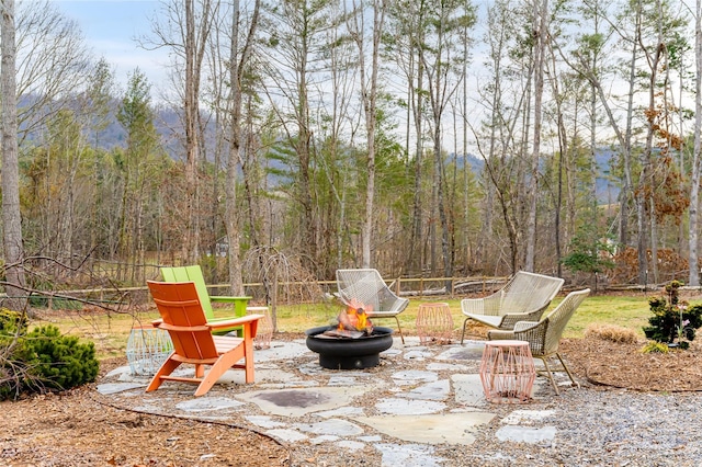 view of patio with an outdoor fire pit and a mountain view