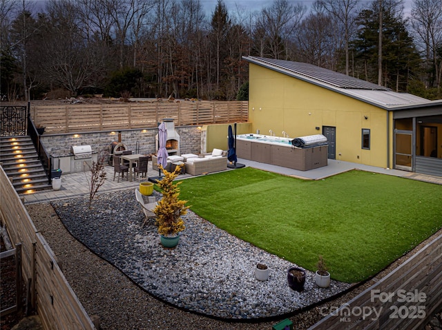 view of yard with a hot tub, outdoor lounge area, area for grilling, and a patio area