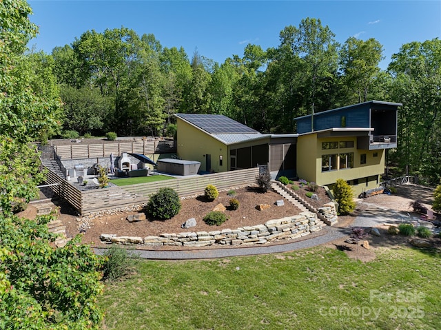 15 Sourwood Ln, Fletcher, NC 28732 - rear view of house with a lawn, a sunroom, and solar panels