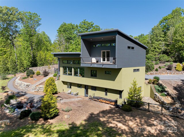 15 Sourwood Ln, Fletcher, NC 28732 - rear view of house with a balcony, stucco siding, and fence