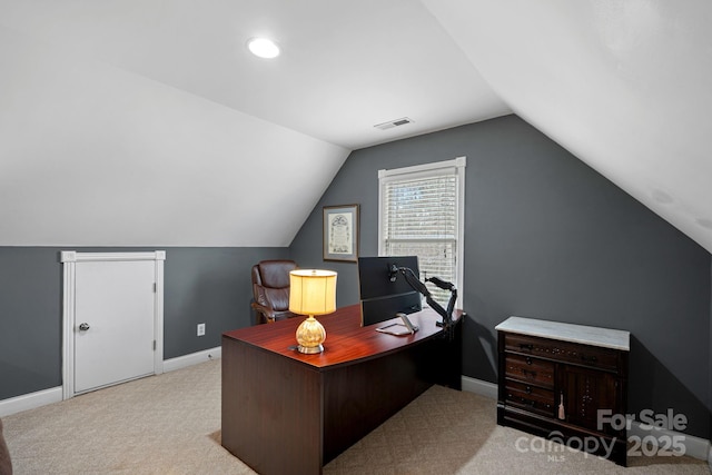 office area featuring light carpet and lofted ceiling