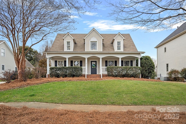 cape cod-style house with a porch and a front yard