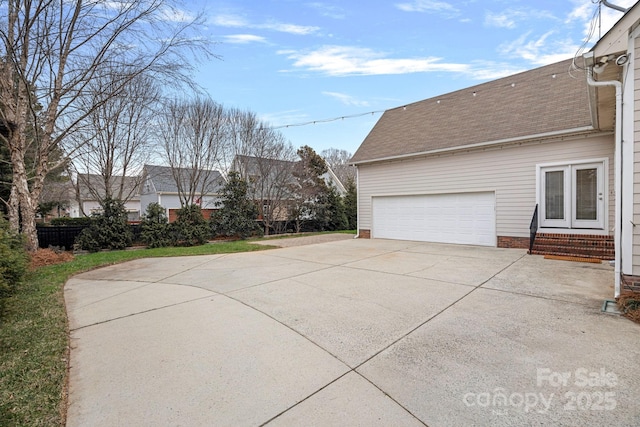 view of side of property with a garage